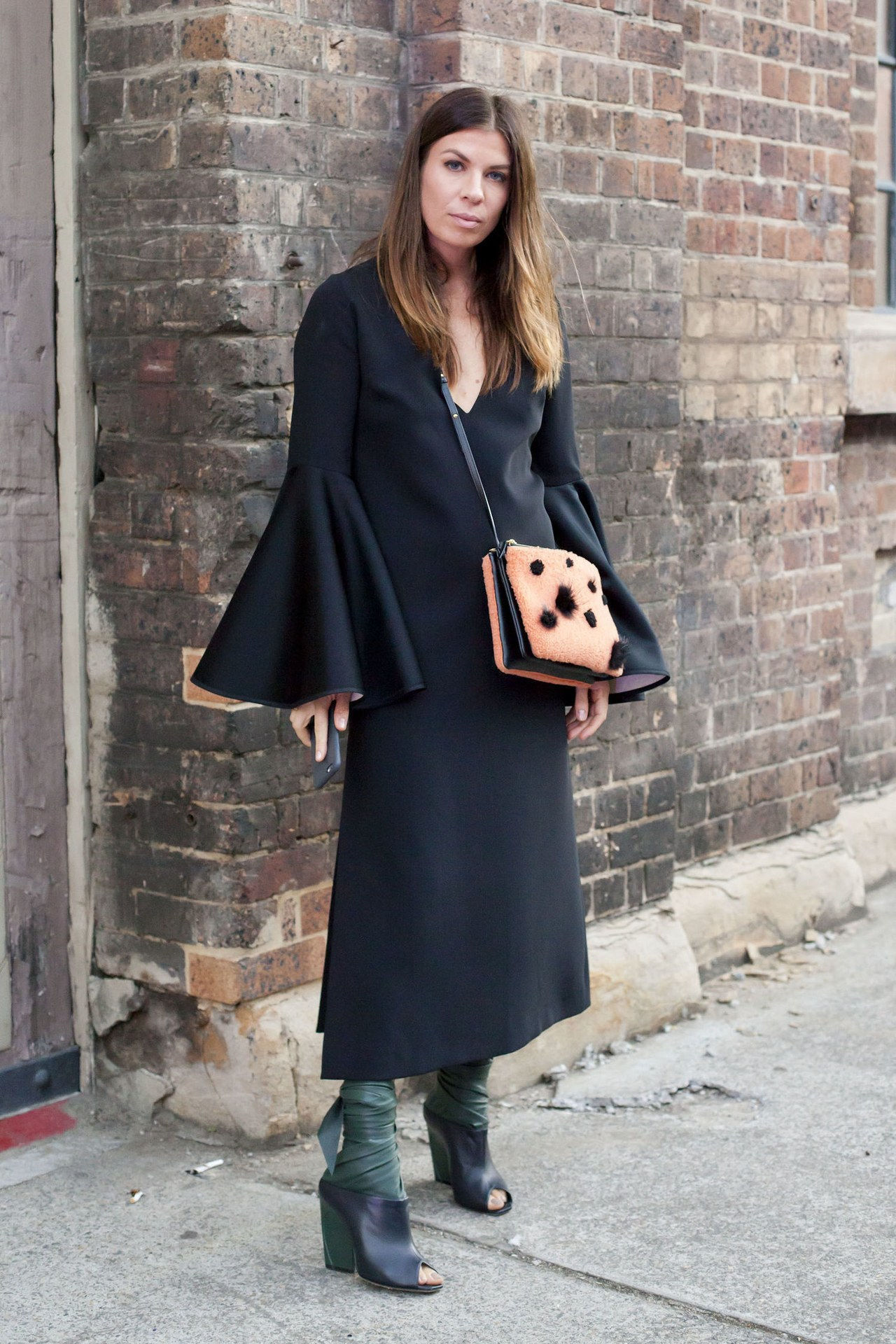 جرس sleeve top outfit ideas black dress chunky heels getty images